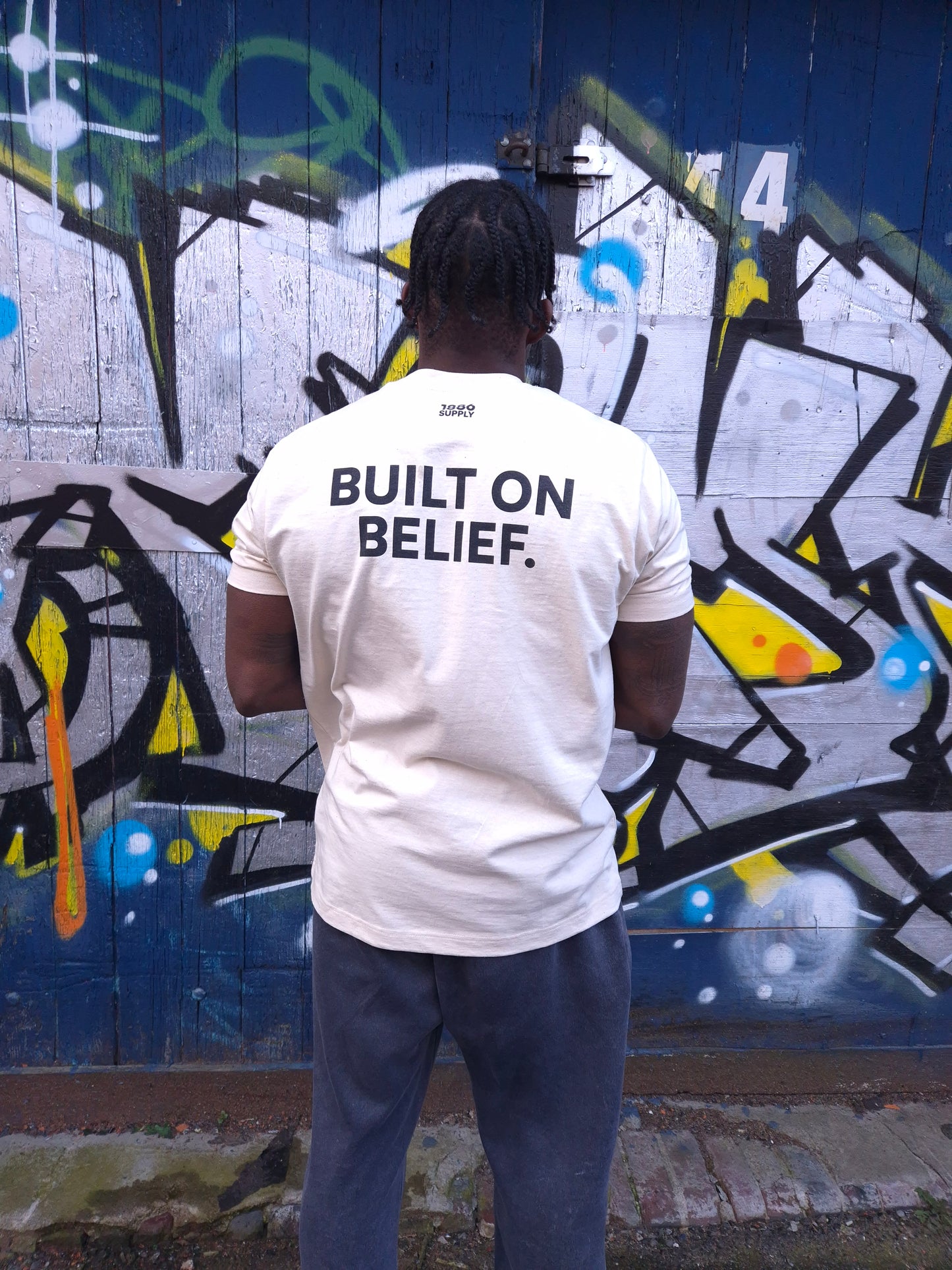 BUILT ON BELIEF T-SHIRT — OFF WHITE